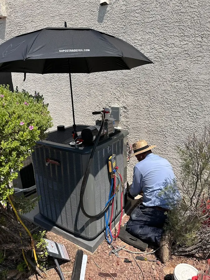 HVAC technician performing outdoor AC maintenance in Corona